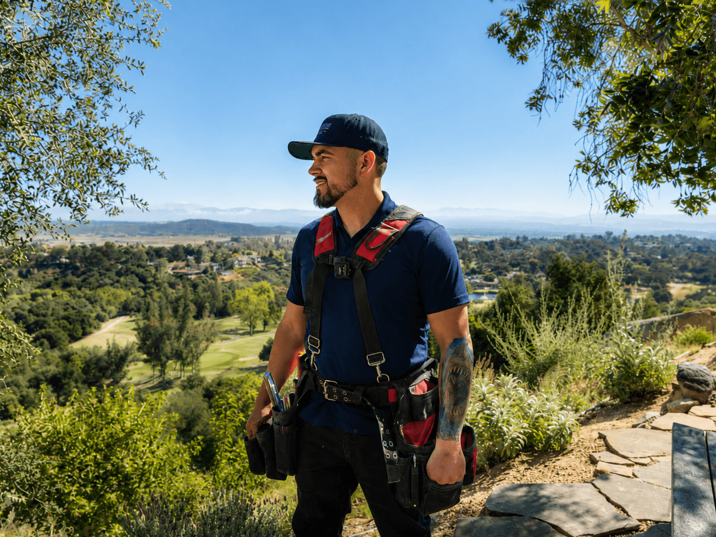 Grade A Plumbing plumber standing outdoors overlooking a suburban landscape